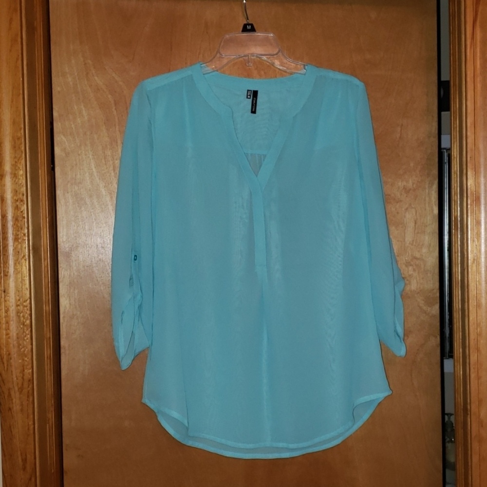 Women's size medium light blue shirt.